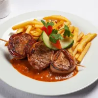 Pan-seared pork tenderloin wrapped in bacon